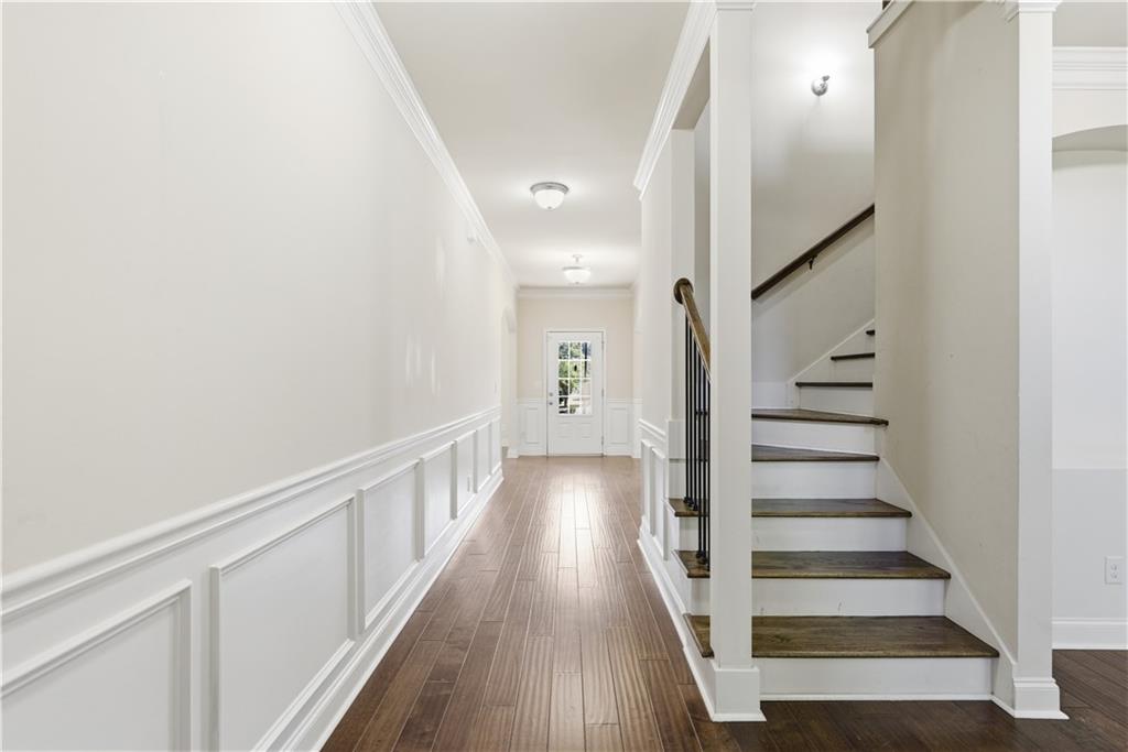 2573 Madison Mae Lane Grayson, GA 30017 - Photo 32 of 51 a view of staircase with wooden floor and white walls