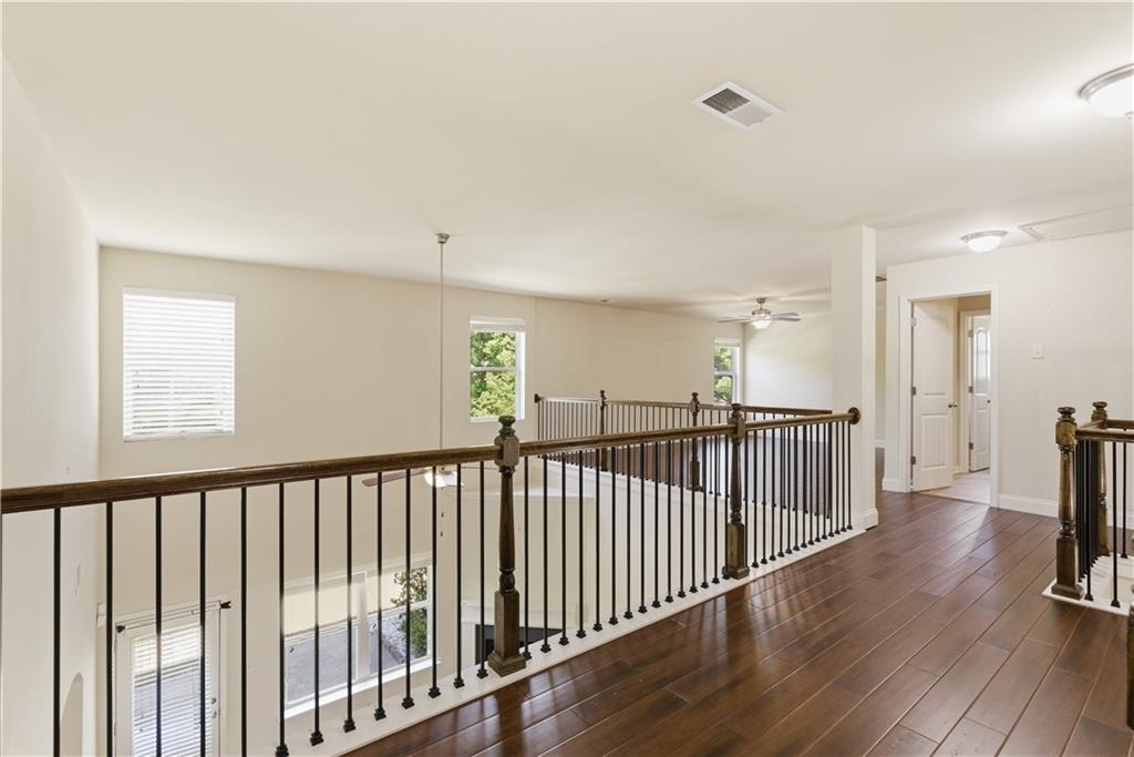 2573 Madison Mae Lane Grayson, GA 30017 - Photo 33 of 51 a view of a hallway with wooden floor and windows