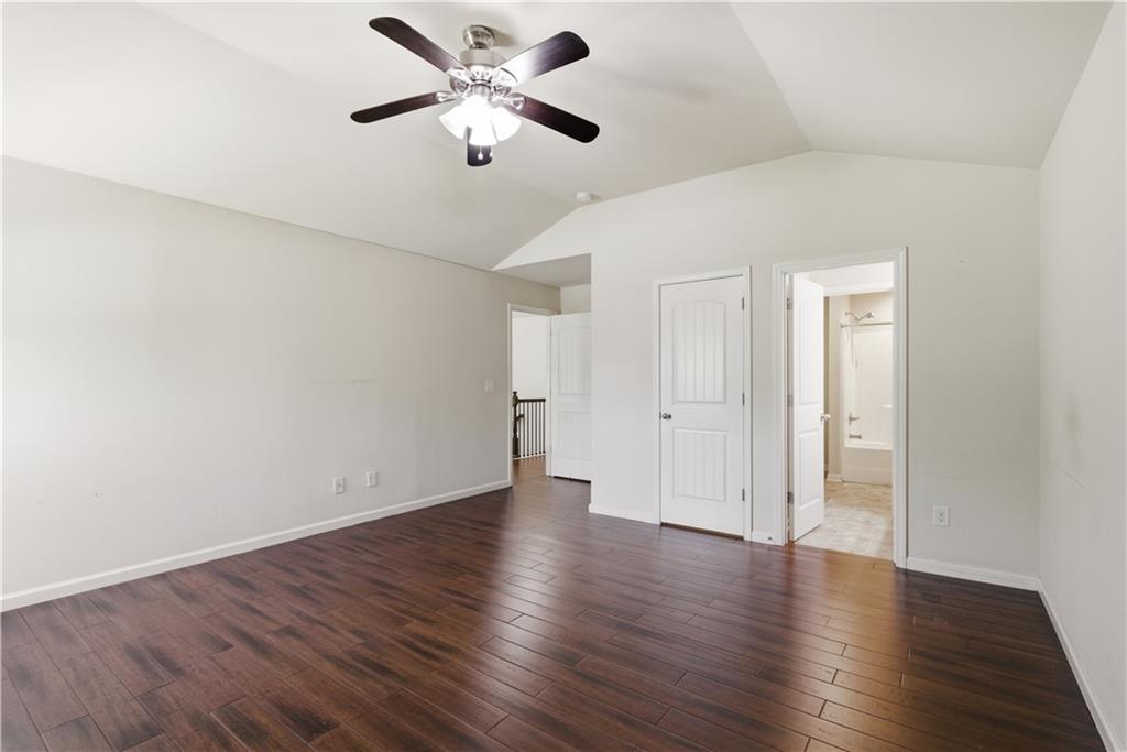 2573 Madison Mae Lane Grayson, GA 30017 - Photo 38 of 51 an empty room with wooden floor and ceiling fan
