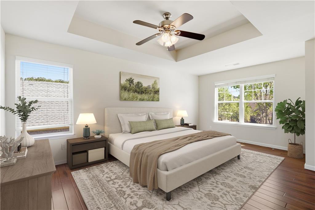 2573 Madison Mae Lane Grayson, GA 30017 - Photo 6 of 51 a spacious bedroom with a large bed a chandelier and a couch