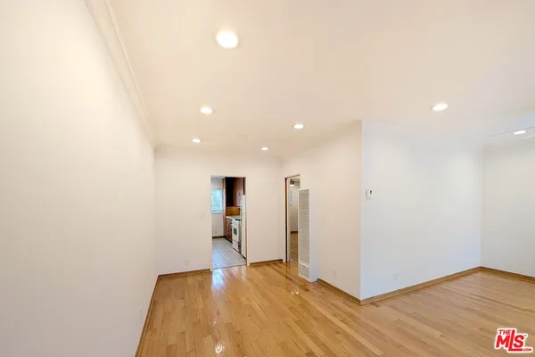 a view of hallway with wooden floor