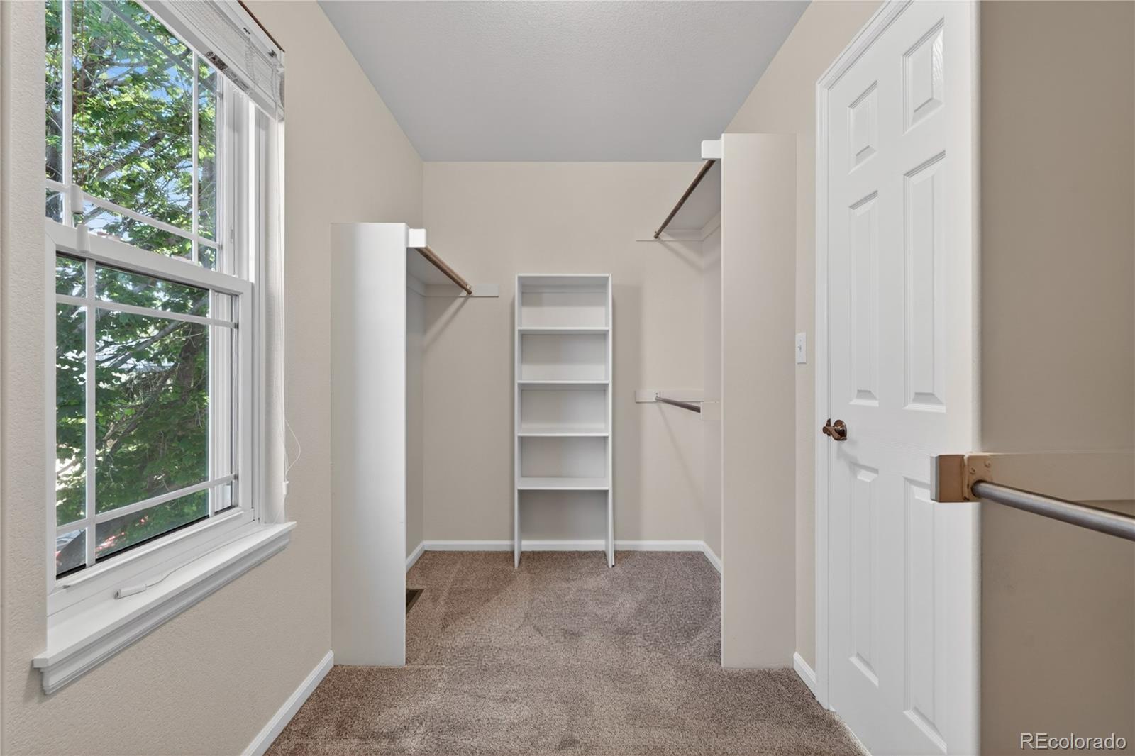 1774 Spring Water Place Highlands Ranch, CO 80129 - Photo 25 of 49 a view of an empty room with a window and a hallway