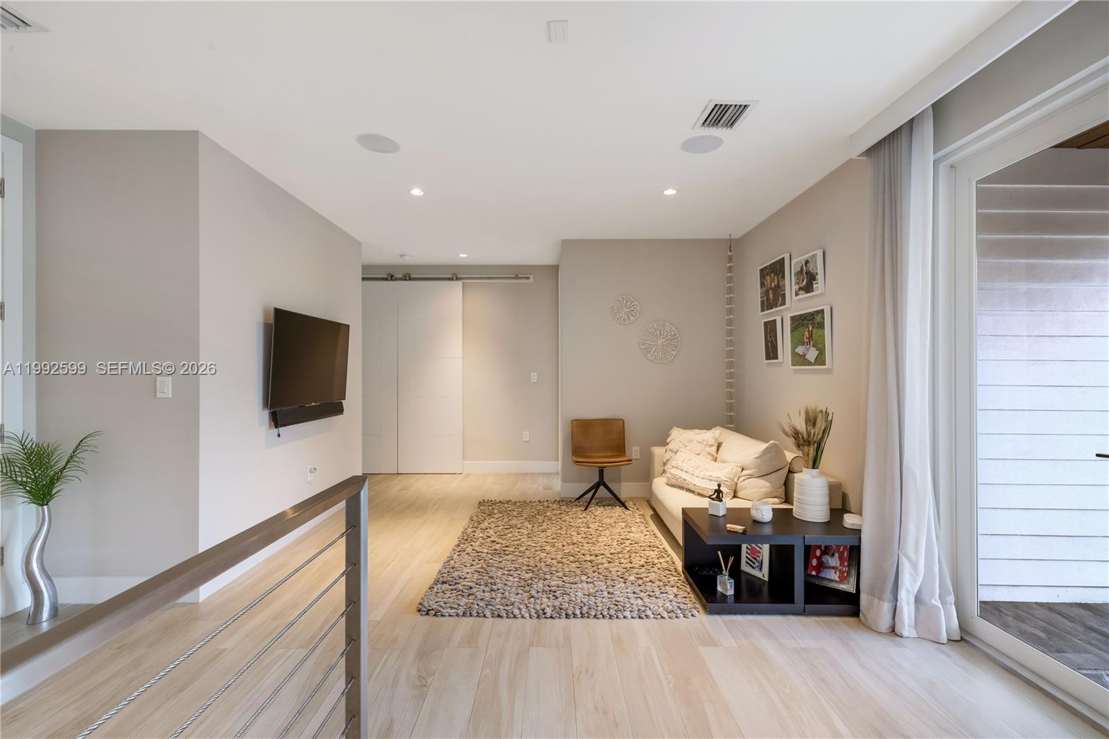 5602 Southwest 65th Court South Miami, FL 33143 - Photo 12 of 68 a living room with furniture and a flat screen tv
