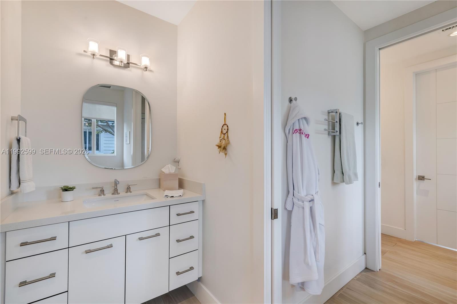 5602 Southwest 65th Court South Miami, FL 33143 - Photo 14 of 68 a bathroom with a double vanity sink and a mirror