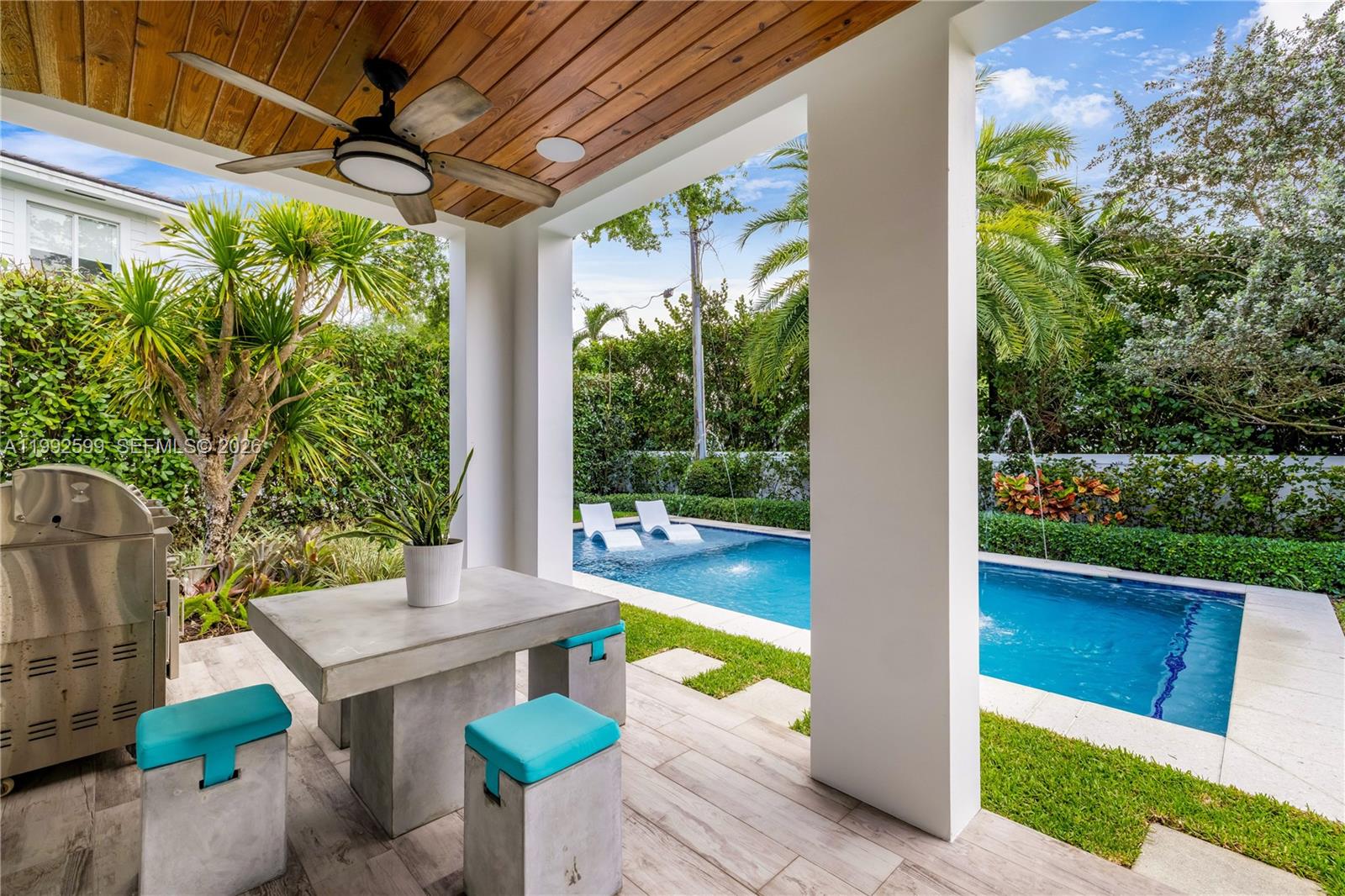 5602 Southwest 65th Court South Miami, FL 33143 - Photo 16 of 68 a view of a patio with table and chairs potted plants with floor to ceiling window and potted plants