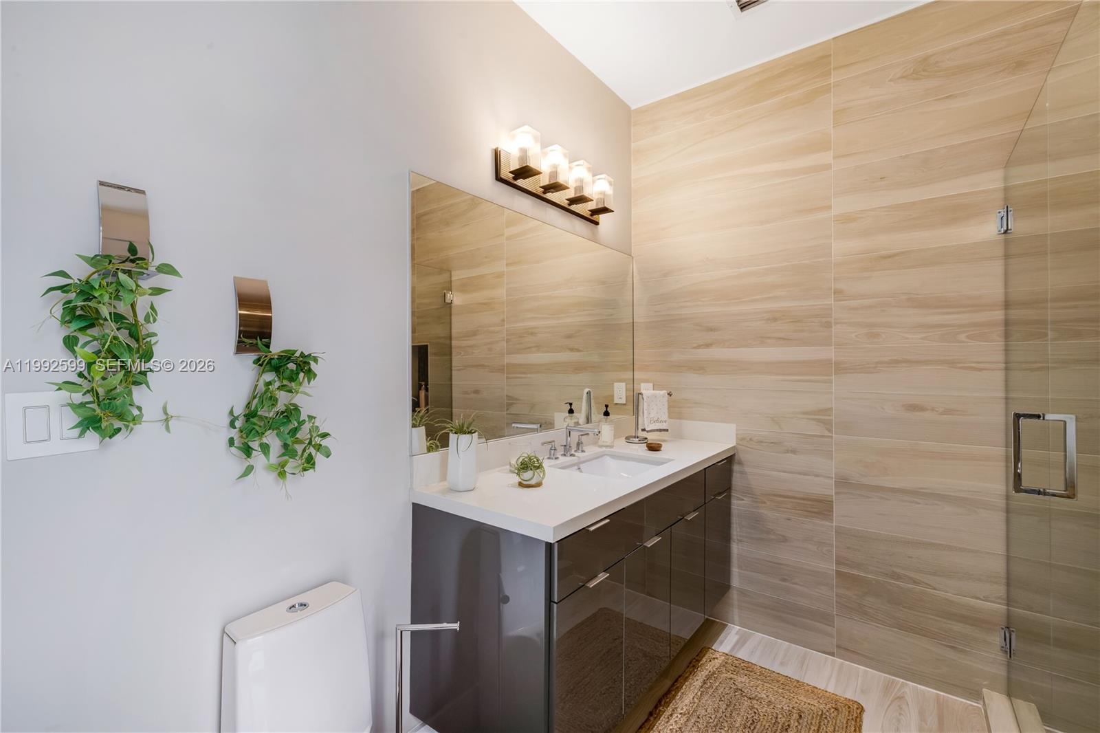 5602 Southwest 65th Court South Miami, FL 33143 - Photo 21 of 68 a bathroom with a sink a potted plant and a mirror