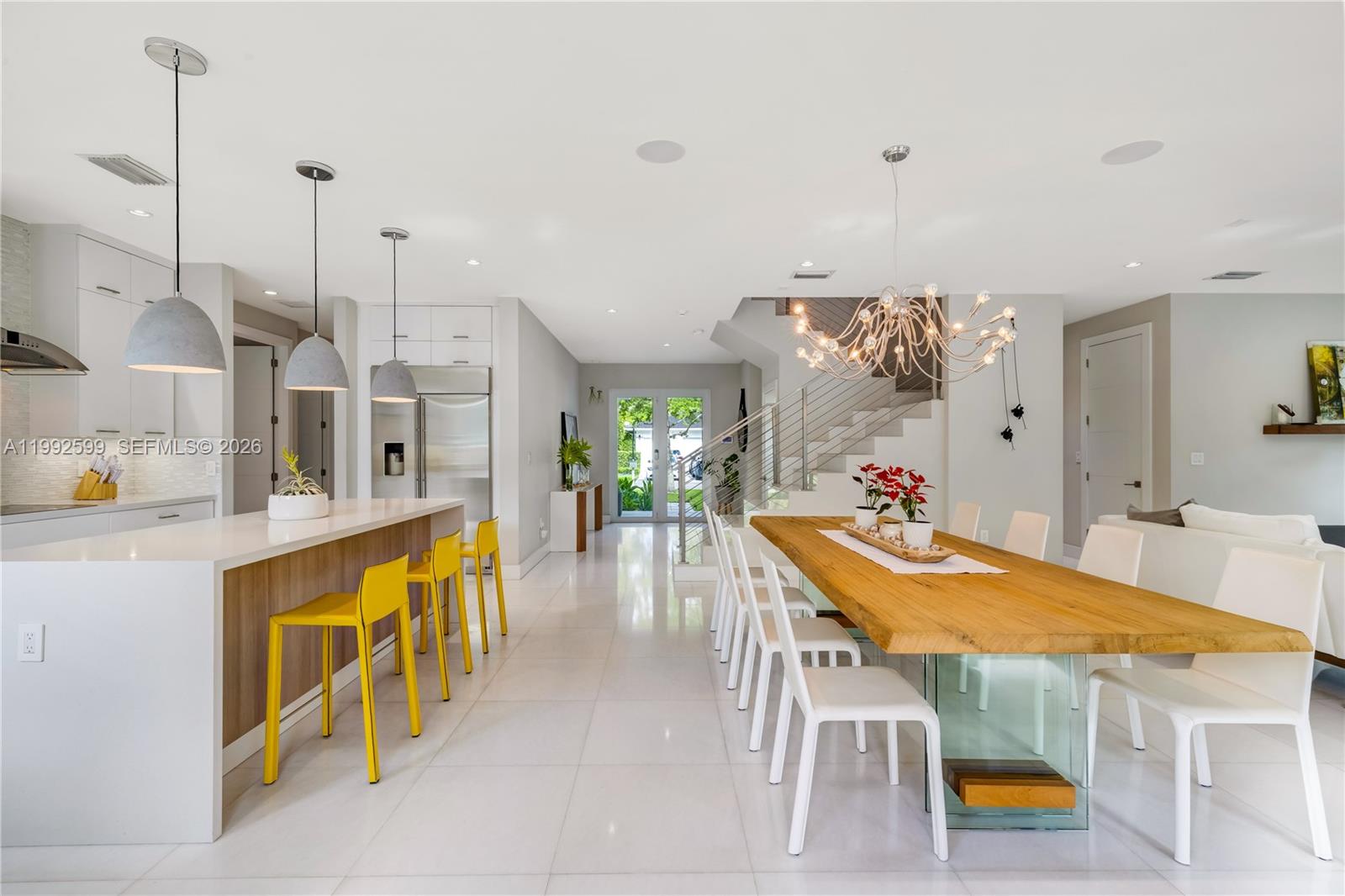 5602 Southwest 65th Court South Miami, FL 33143 - Photo 33 of 68 a kitchen with stainless steel appliances kitchen island granite countertop a table and chairs