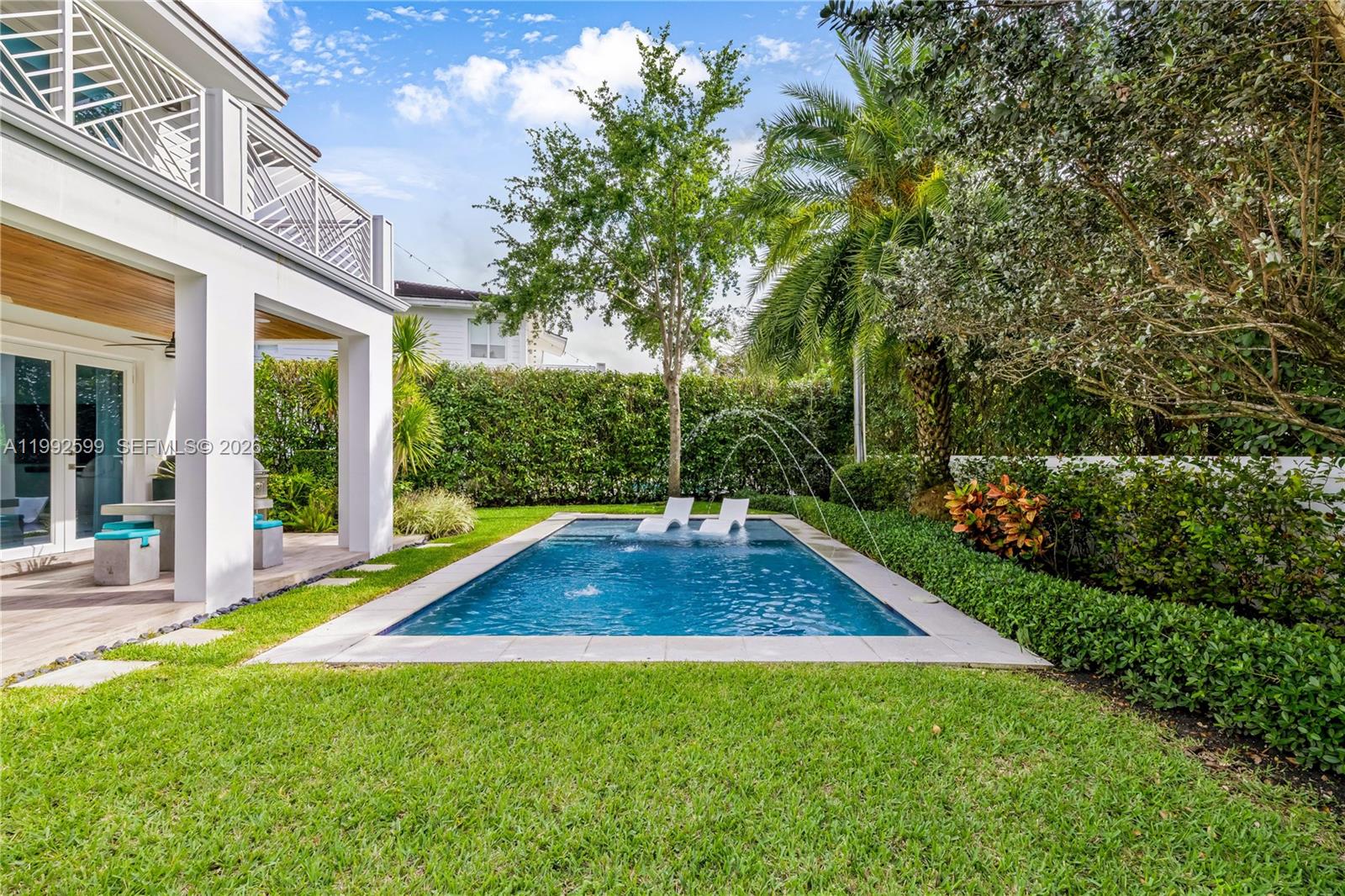 5602 Southwest 65th Court South Miami, FL 33143 - Photo 35 of 68 a view of backyard with swimming pool and green space