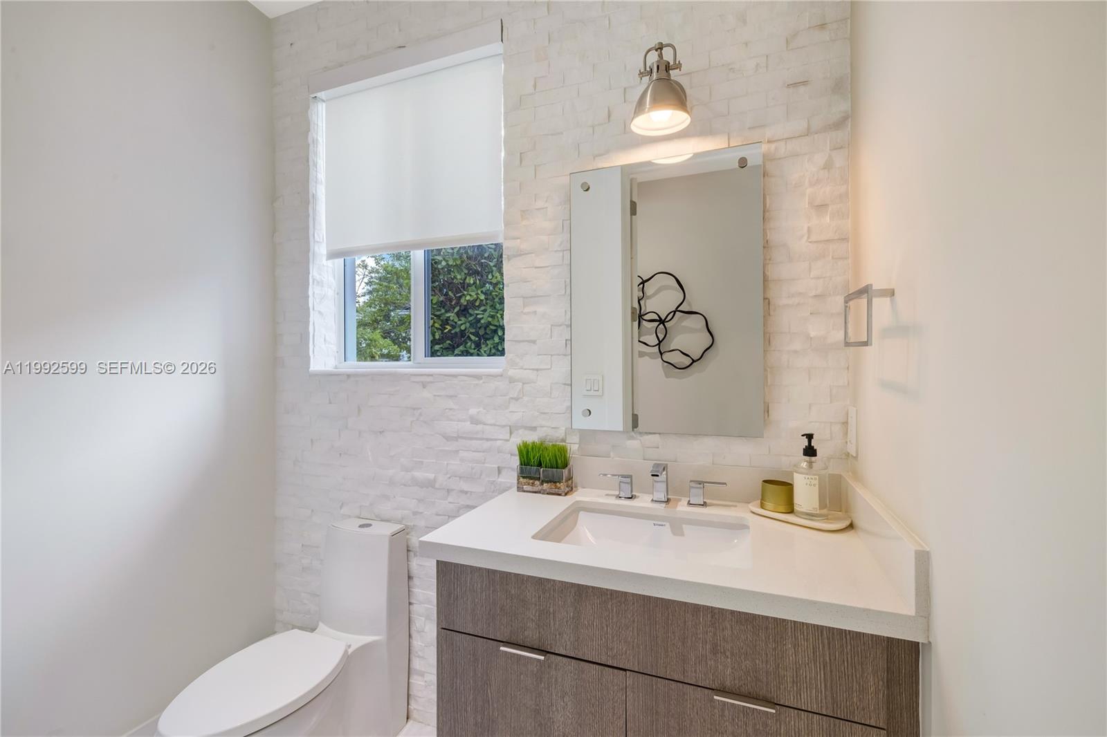5602 Southwest 65th Court South Miami, FL 33143 - Photo 48 of 68 a bathroom with a sink toilet and window