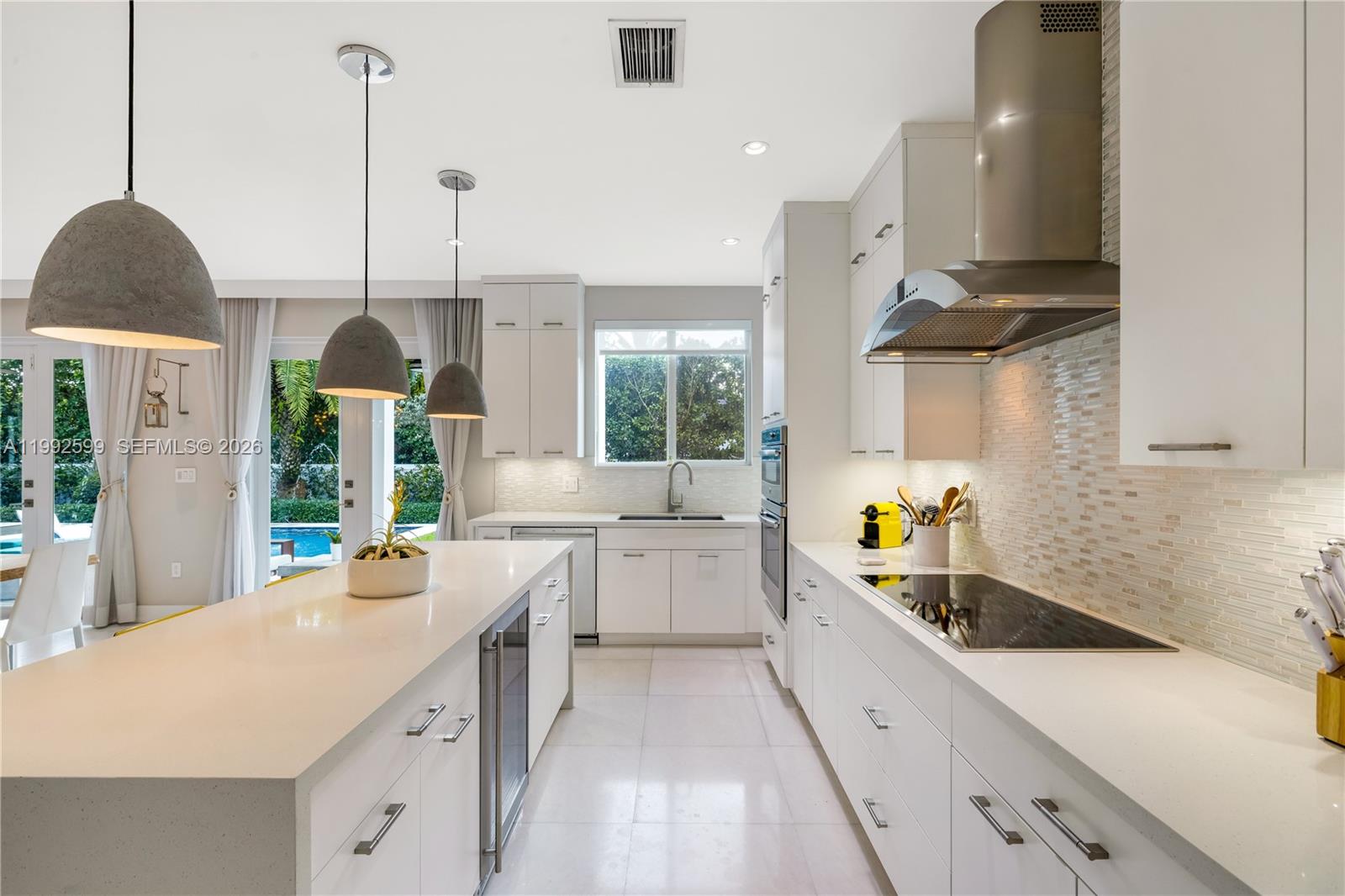 5602 Southwest 65th Court South Miami, FL 33143 - Photo 8 of 68 a large kitchen with stainless steel appliances a lot of counter space and a wooden floor