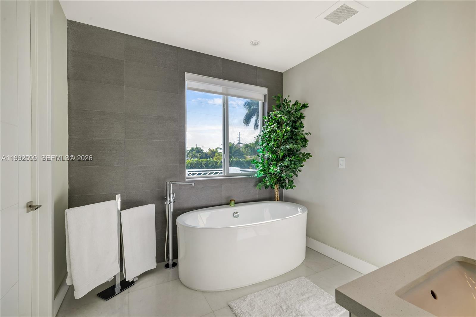 5602 Southwest 65th Court South Miami, FL 33143 - Photo 10 of 68 a white bath tub sitting in a bathroom