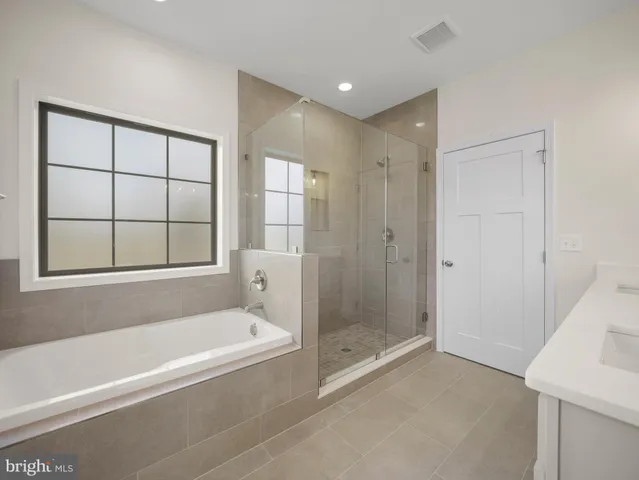 a bathroom with a bathtub and shower