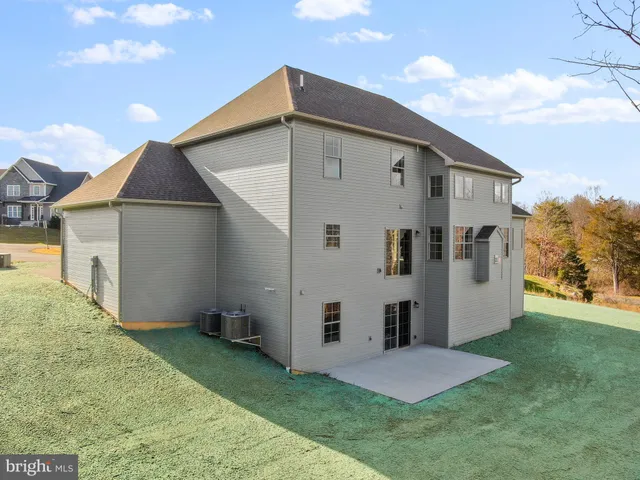 a front view of house with yard and trees