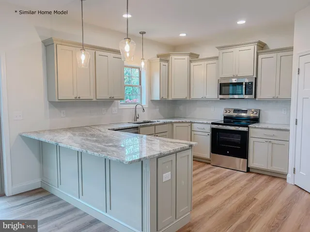 a kitchen with a sink stove top oven and cabinets