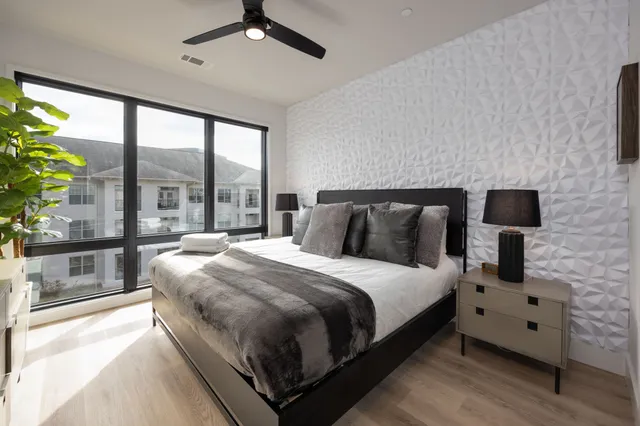 a bedroom with a bed and a lamp