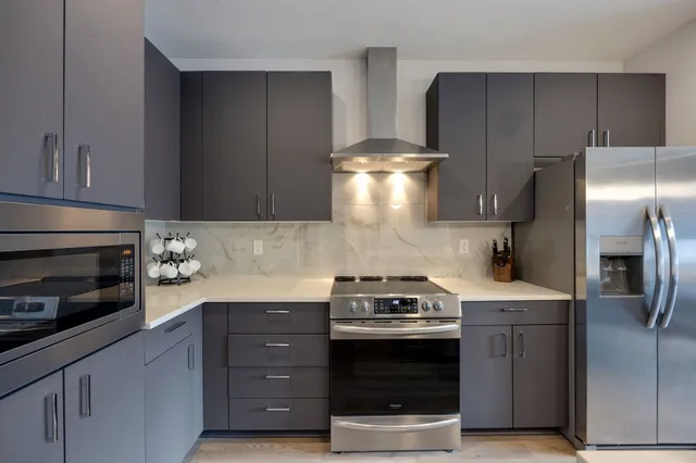 a kitchen with a stove and a refrigerator