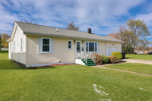 a front view of house with yard and green space