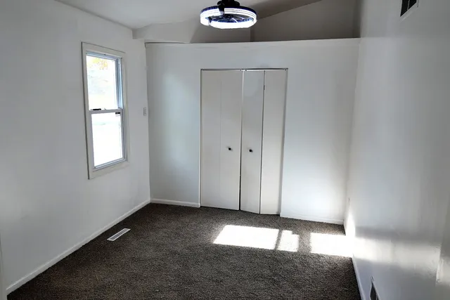 a view of wooden floor and windows in a room