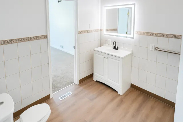 a bathroom with a sink toilet a mirror and shower