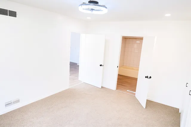 a view of a hallway with wooden floor