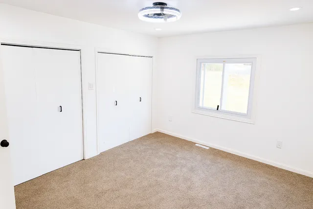 a view of an empty room with a window