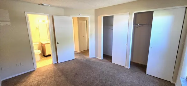 a view of a room with furniture and wooden door