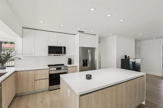 a kitchen with a sink a stove and refrigerator
