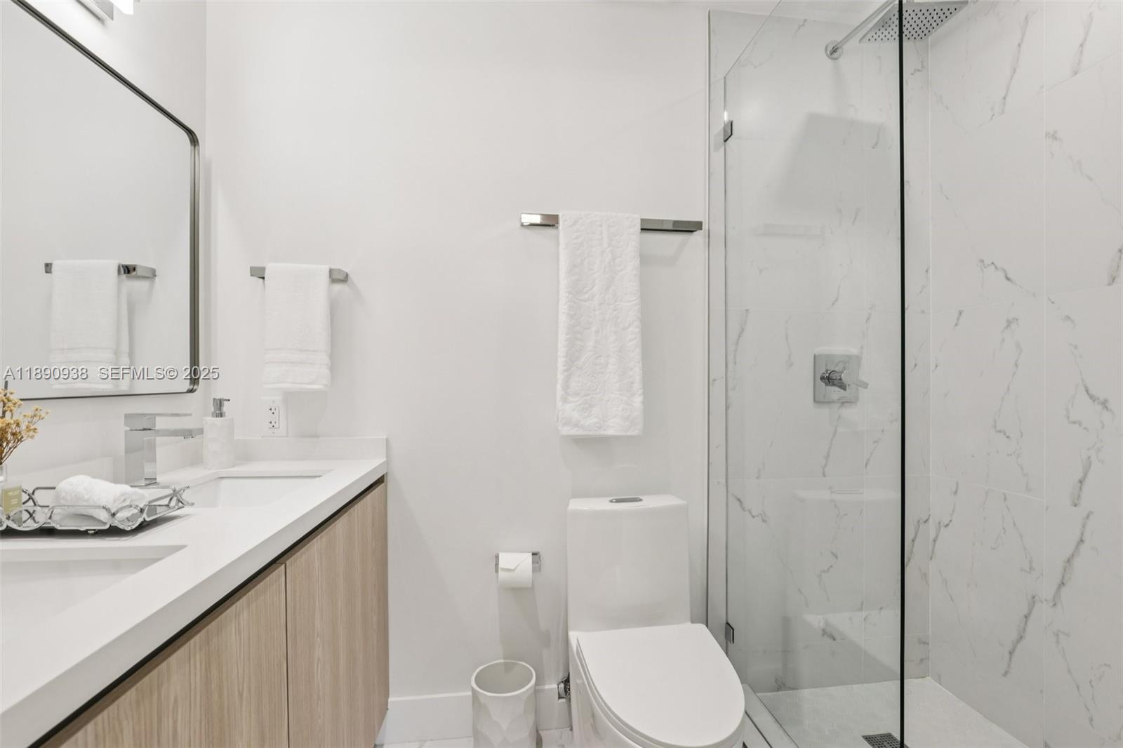 1960 Northeast 32nd Street Lighthouse Point, FL 33064 - Photo 19 of 40 a bathroom with a granite countertop sink toilet and shower