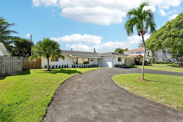 a house with swimming pool in front of it
