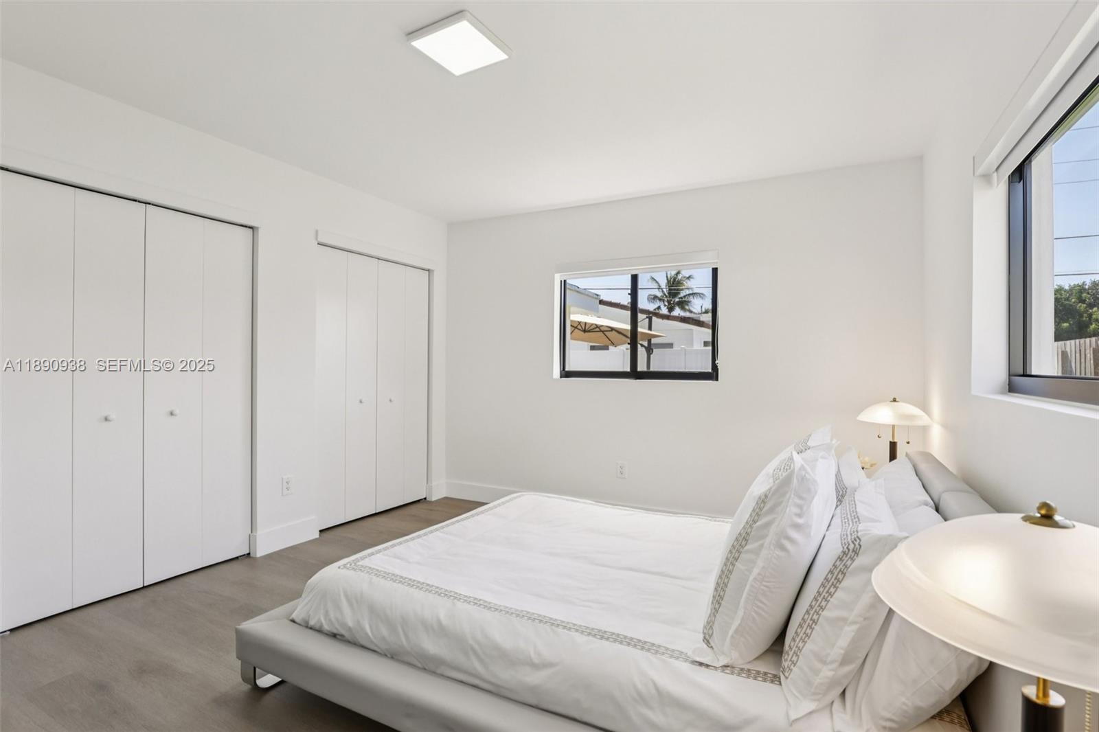 1960 Northeast 32nd Street Lighthouse Point, FL 33064 - Photo 22 of 40 a bedroom with a bed and a chair