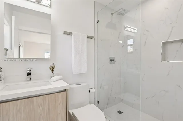 a bathroom with a sink toilet and shower