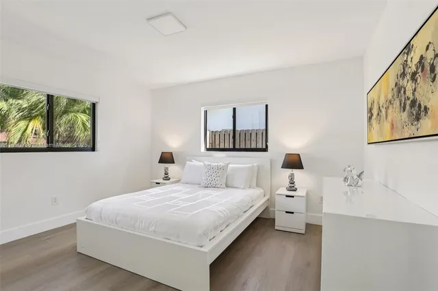 a bedroom with a bed and a night stand