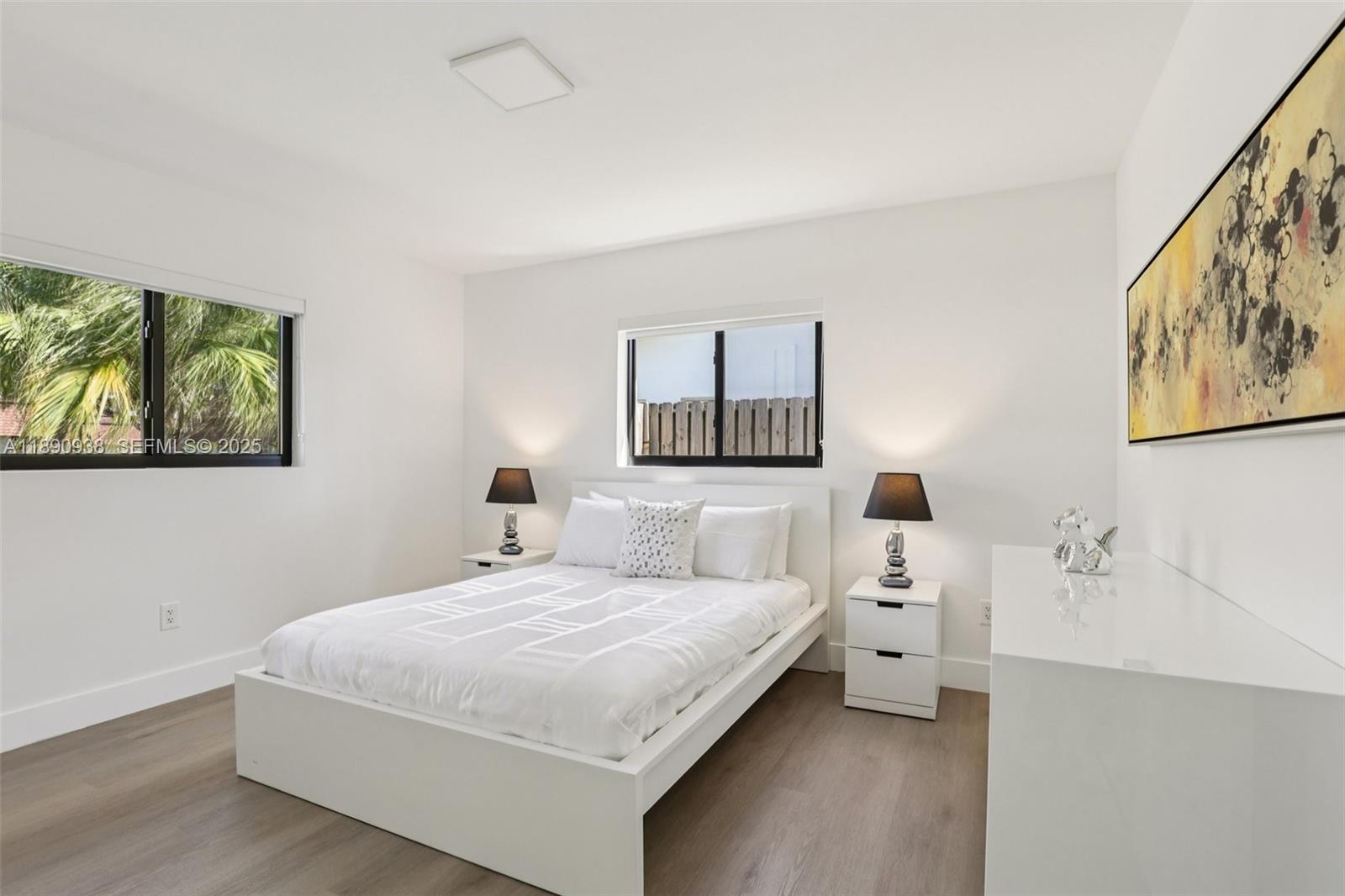 1960 Northeast 32nd Street Lighthouse Point, FL 33064 - Photo 25 of 40 a bedroom with a bed and a night stand