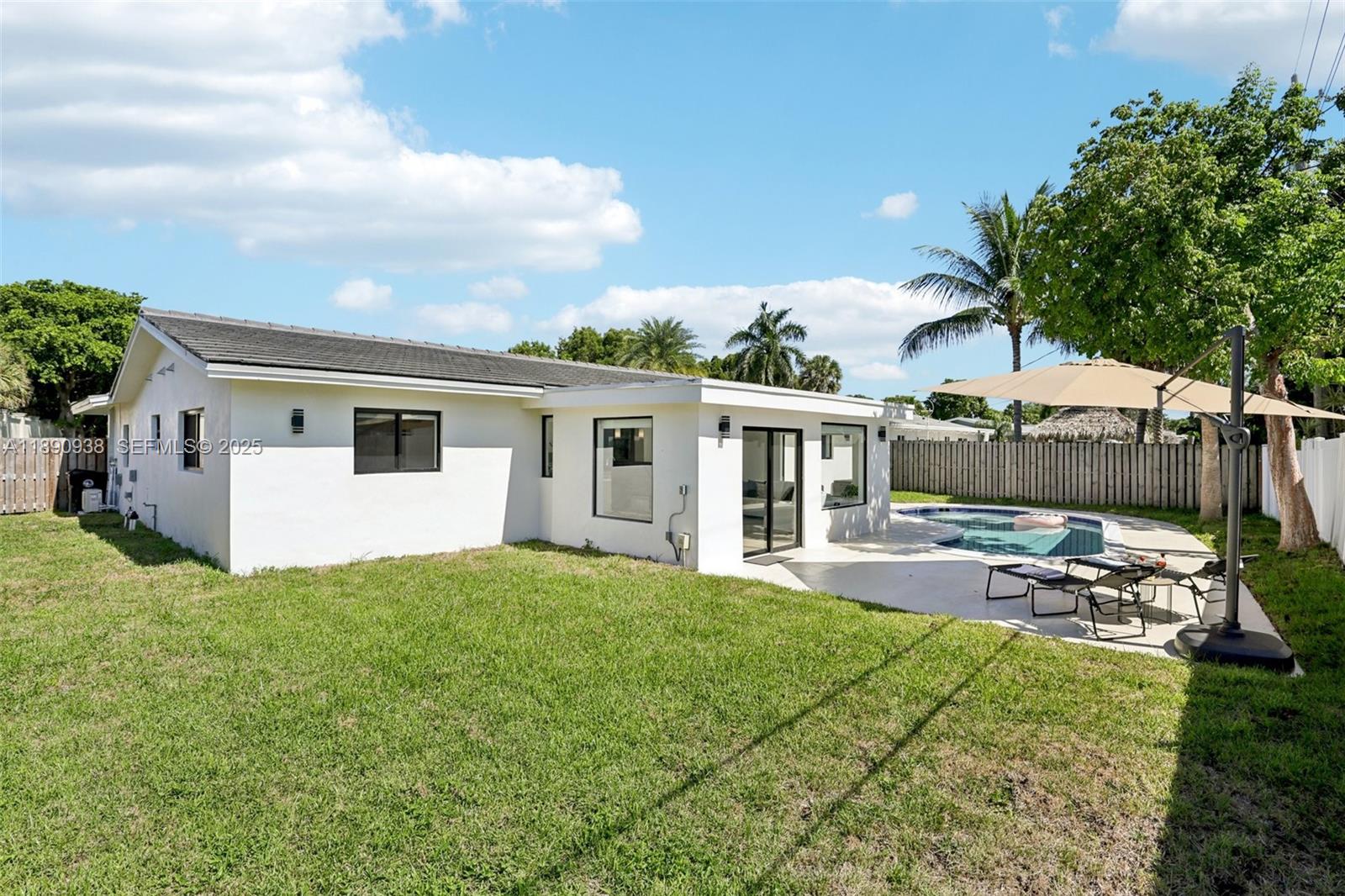 1960 Northeast 32nd Street Lighthouse Point, FL 33064 - Photo 34 of 40 a view of a house with backyard and sitting area