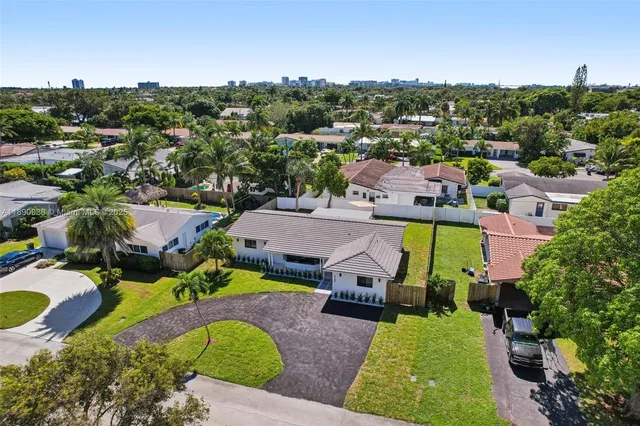 an aerial view of a house with a swimming pool yard and outdoor seating