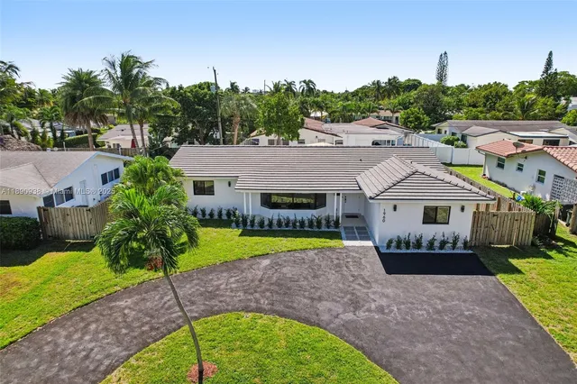 a house with green field in front of it