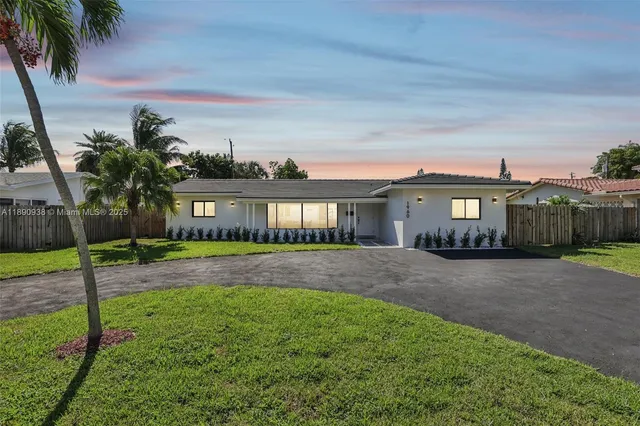 a front view of a house with a yard and glass windows