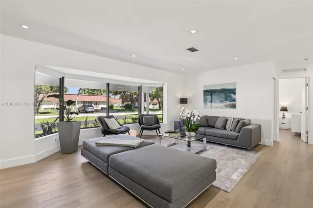 a living room with furniture and a large window