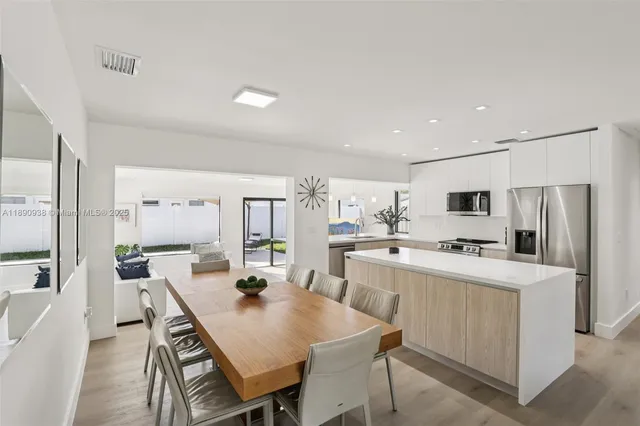 a large kitchen with a table and chairs