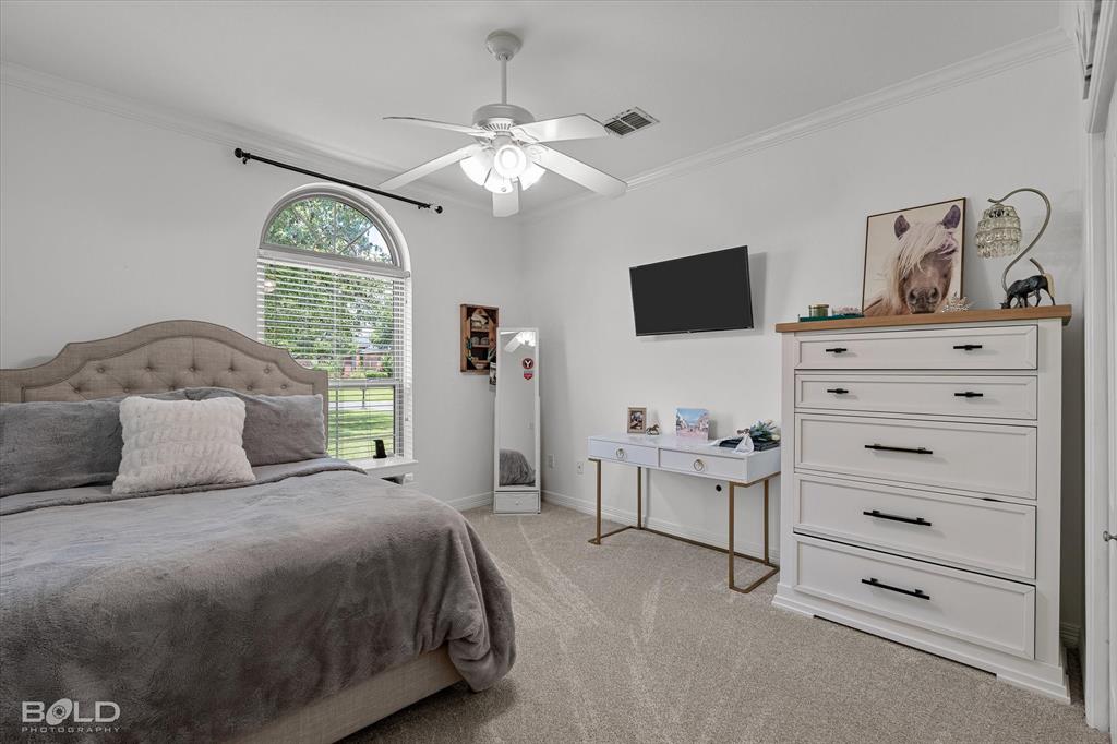 116 Augusta Avenue Benton, LA 71006 - Photo 27 of 38 a bedroom with a bed and a flat screen tv