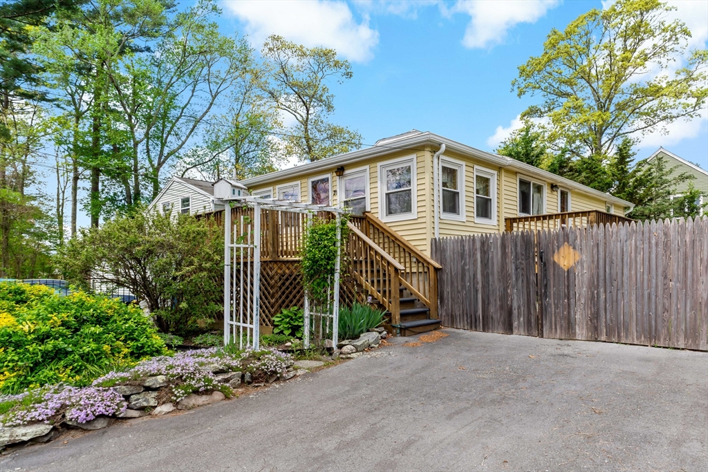 31 Mayflower Road Norton, MA 02766 - Photo 3 of 23 a front view of a house with glass windows and plants