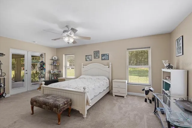 a bedroom with a bed and ceiling fan