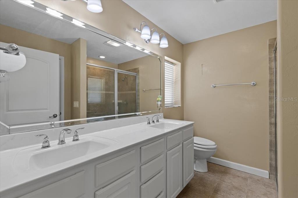 4700 Northwest 55th Avenue Bell, FL 32619 - Photo 13 of 77 a bathroom with a sink double vanity and a mirror