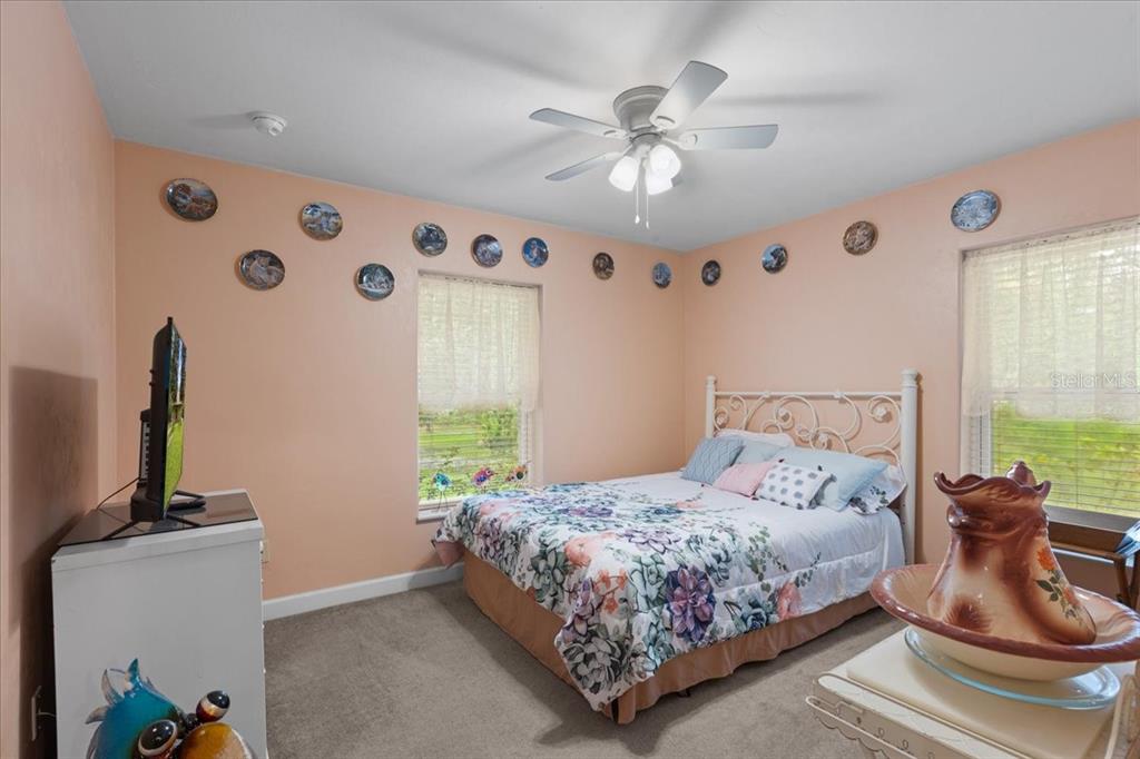 4700 Northwest 55th Avenue Bell, FL 32619 - Photo 15 of 77 a bedroom with a bed and ceiling fan