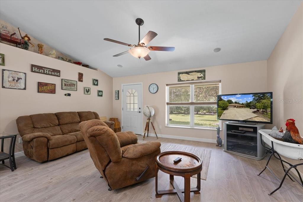 4700 Northwest 55th Avenue Bell, FL 32619 - Photo 2 of 77 a living room with furniture a window and a flat screen tv