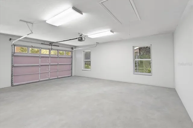 an aerial view of residential house with outdoor space and trees all around