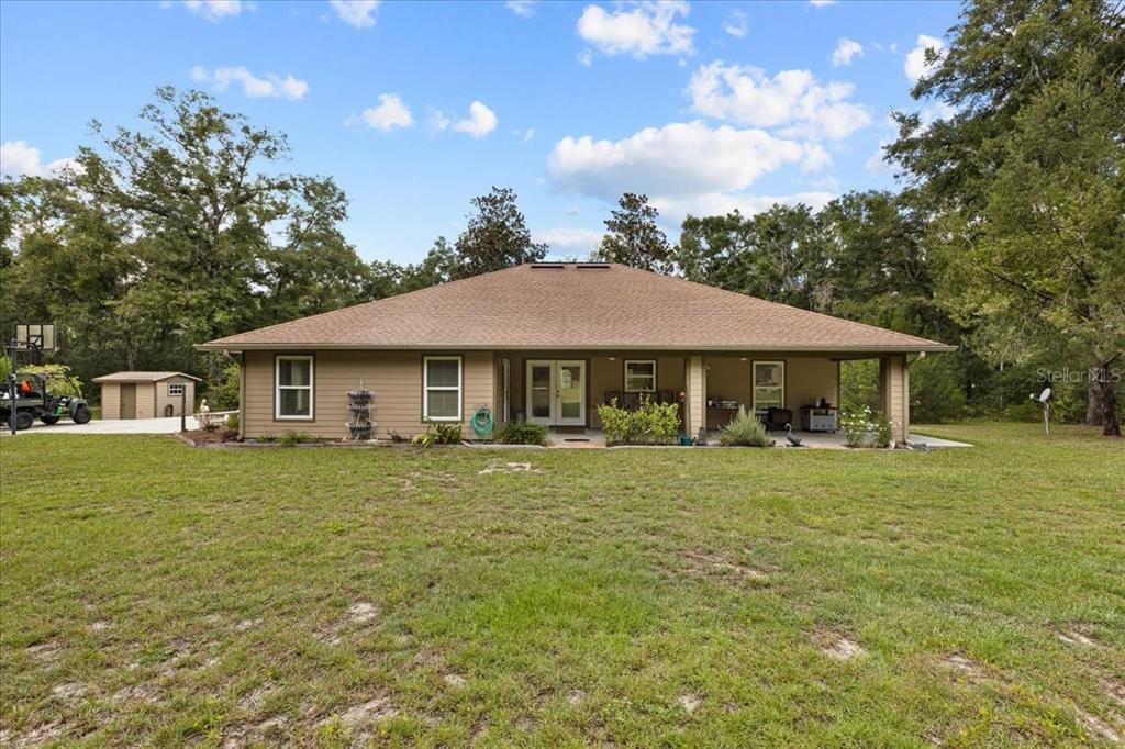 4700 Northwest 55th Avenue Bell, FL 32619 - Photo 24 of 77 a front view of a house with a garden