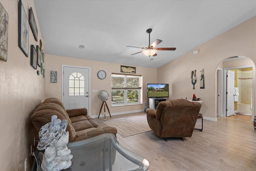 4700 Northwest 55th Avenue Bell, FL 32619 - Photo 3 of 77 a living room with furniture a flat screen tv and a large window