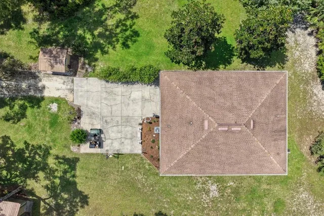 a view of a house with backyard porch and sitting area