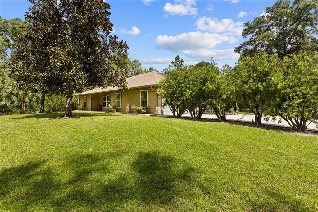 4700 Northwest 55th Avenue Bell, FL 32619 - Photo 41 of 77 a front view of house with yard and trees
